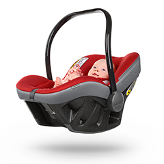 Baby sitting in red, grey and black car baby seat