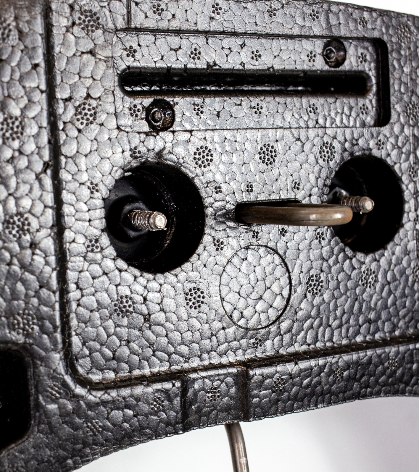 A close up view of a automotive seating system made from ARPRO, showing moulding around metal