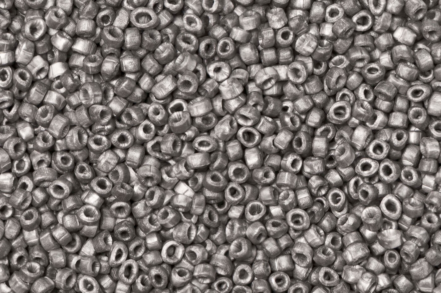 Close-up of grey ring shaped expanded foam beads specifically engineered for acoustic applications