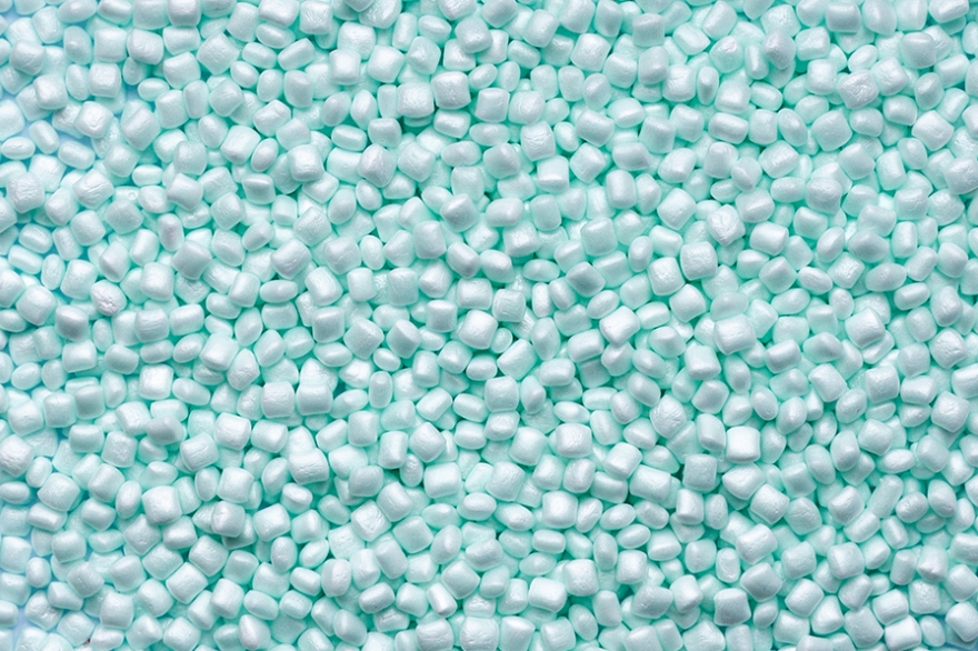 Close-up of pale sea green expanded foam beads made from maritime industry waste.