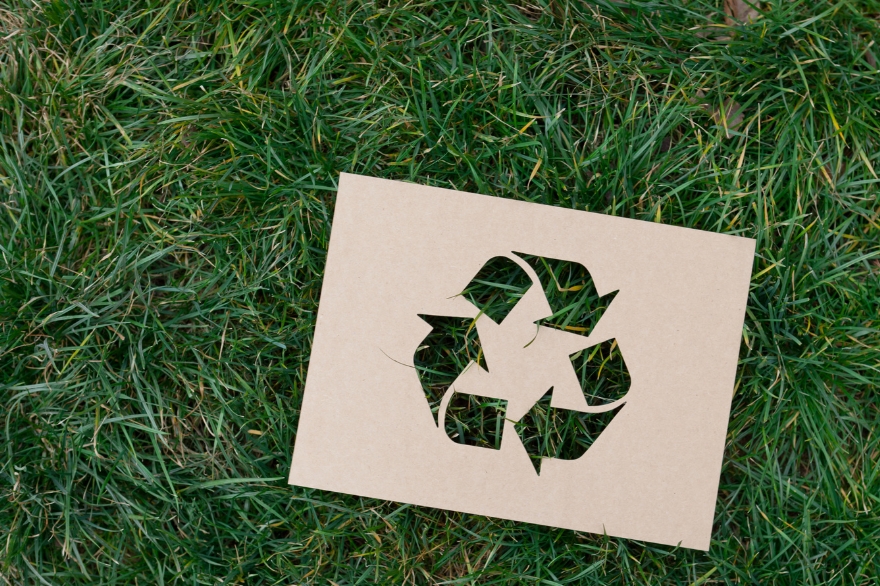 Green grass with a recycling logo to show circular economy