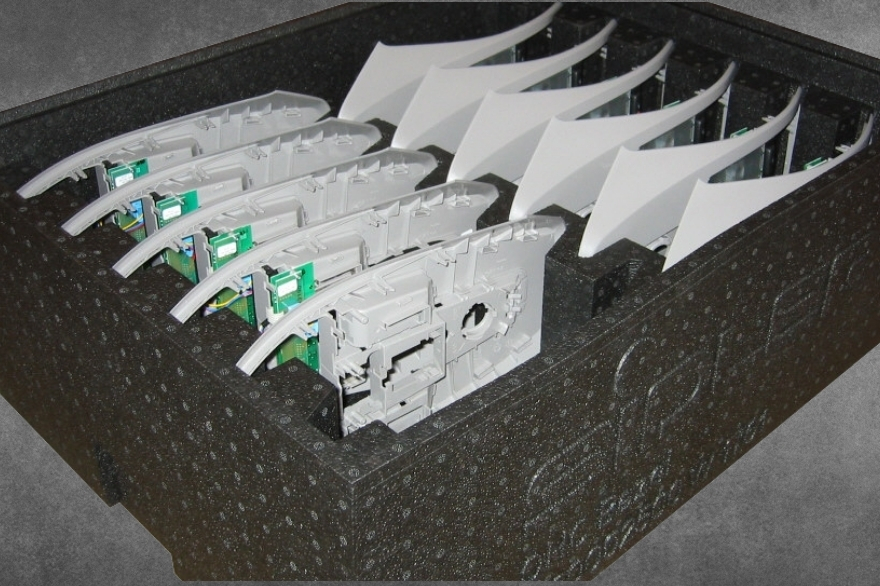 Reusable dunnage packaging with automotive sun visors. The box is made from black ARPRO.
